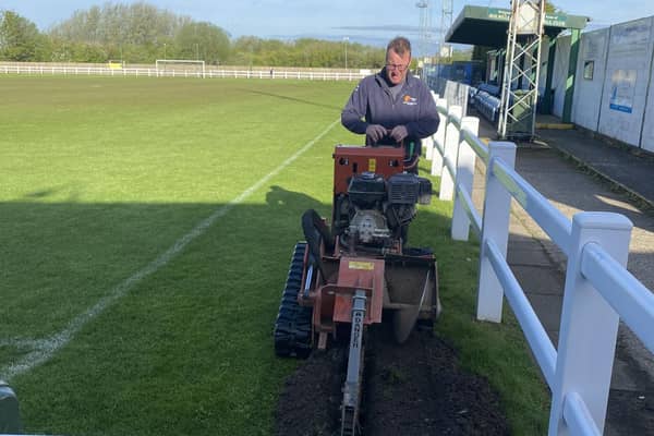Holwell Sports groundsman Carel Fourie working on the new floodlight bases