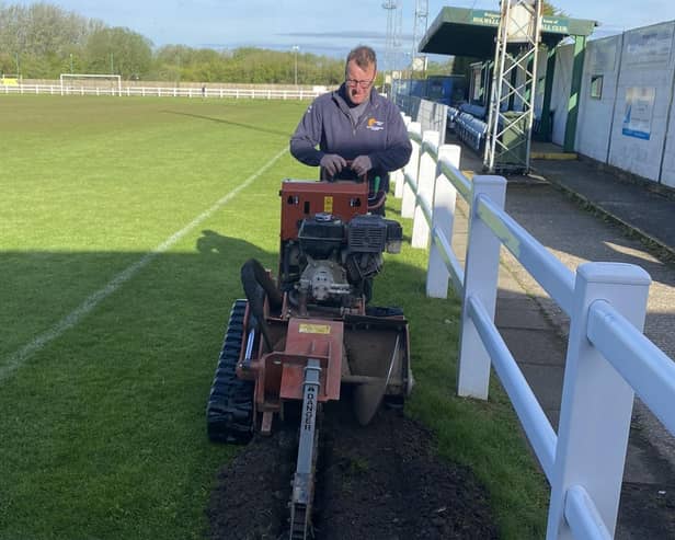 Holwell Sports groundsman Carel Fourie working on the new floodlight bases