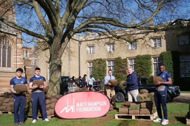Rugby School pupils load up turf from their iconic rugby field ready for it to be delivered to the Get Busy Living Centre rehab facility at Burrough on the Hill