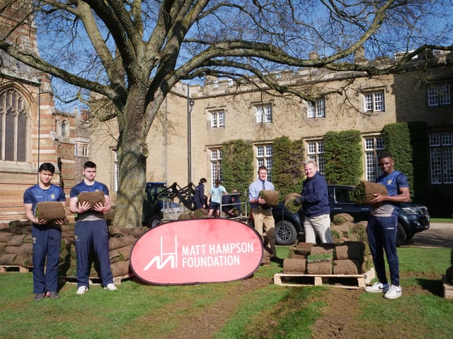 Rugby School pupils load up turf from their iconic rugby field ready for it to be delivered to the Get Busy Living Centre rehab facility at Burrough on the Hill