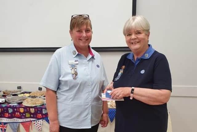 Jane White (right) receives her 50-year service award from Sam Harrold, Girlguiding Leicestershire's county commissioner.