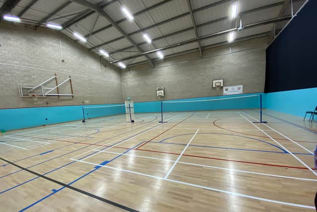 The reduced sports hall at Melton Sports Village with the retractable screen to the right behind which the new soft play area is now