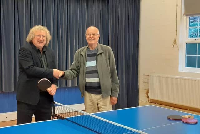 Phil Gaskell, from the Sir John Sedley Educational Foundation, hands over the new table tennis table at Wymondham Village Hall