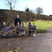 Children from the Roots to Wings nursery campaign on the roadside to stop drivers speeding through Wymondham