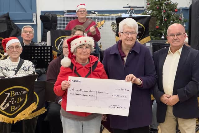 The Melton Parkinson's Group is presented with a cheque by Belvoir Big Band