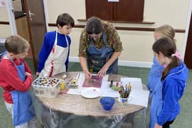 Donna Drouin teaching children at an art class