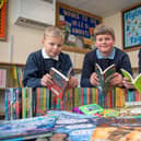 Swallowdale Primary School pupils leaf through some of the new books gifted by Barratt Homes