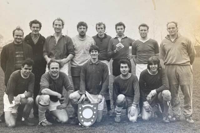 Baz Cousins (extreme right of front row) lines up with team mates to celebrate victory in a football competition