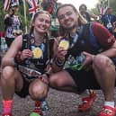 Jordan Meads and Beth Pattern with their medals after running the London Marathon in crocs sandals