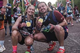 Jordan Meads and Beth Pattern with their medals after running the London Marathon in crocs sandals