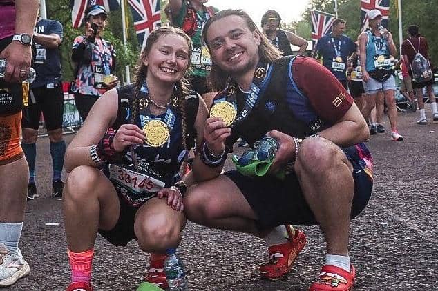 Jordan Meads and Beth Pattern with their medals after running the London Marathon in crocs sandals