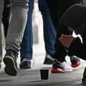 A person kneeling on the pavement begs for money on The Strand in central London on October 1, 2022, as campaigners gather in the city to protest against the cost of living crisis. (Photo by Justin TALLIS / AFP) (Photo by JUSTIN TALLIS/AFP via Getty Images)