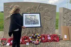 Laura Briggs holds a framed print of Derek Chambers' ‘The Last Stand', presented to her by FOTT chairman Alec Wilson at the 10th Battalion Memorial at Burrough-on-the-Hill