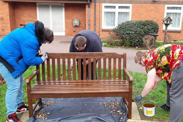 Young people work on seating at Gretton Court retirement complex