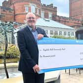 Ragdale Hall Spa managing director, Hugh Wilson, director, Allison Garner, with a cheque for this year's Ragdale Hall Community Chest