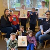 Debra Meakin (right) and Laura Gabriel with some of the children at Cheeky Cherubs Childcare and the LifeVac devices they raised money for