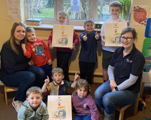 Debra Meakin (right) and Laura Gabriel with some of the children at Cheeky Cherubs Childcare and the LifeVac devices they raised money for