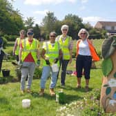 Members of the Friends of Melton Country Park tending the Covid Memorial beds and sculptures