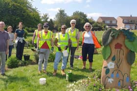 Members of the Friends of Melton Country Park tending the Covid Memorial beds and sculptures