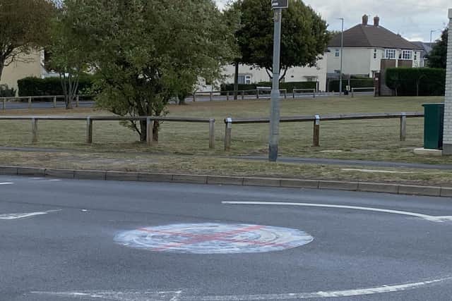 A red cross daubed on a mini roundabout on Dalby Road, Melton, near Swallowdale Primary School
