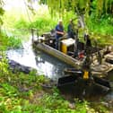 MOWS volunteers aboard their dredging boat Mole in the River Eye