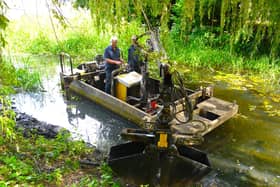 MOWS volunteers aboard their dredging boat Mole in the River Eye