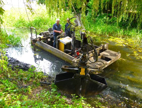 MOWS volunteers aboard their dredging boat Mole in the River Eye