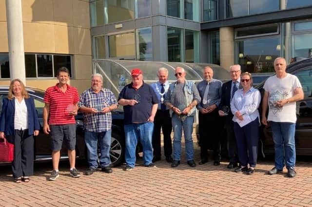 The seven Melton borough taxi drivers after being presented with long-service awards
