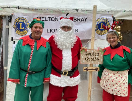 Santa and his elves outside Melton Lions Club's grotto in the Bell Centre