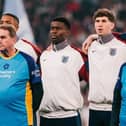 Steve Freer (left) pictured during the national anthem with England stars Mark Guehi and John Stones