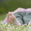 Woman enjoying nature on a summer day in a field of daisies. © Pete Cairns / naturepl.com / WWF