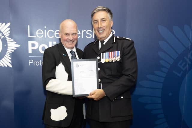 Milkman Tony Fowler receives his commendation award from Leicestershire Chief Constable Rob Nixon