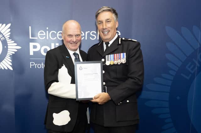 Milkman Tony Fowler receives his commendation award from Leicestershire Chief Constable Rob Nixon