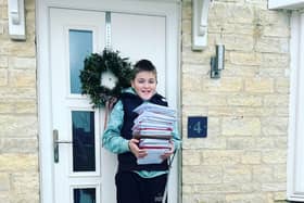 One of the 36th Melton Mowbray Scout Group with a pile of Christmas cards ready to be delivered