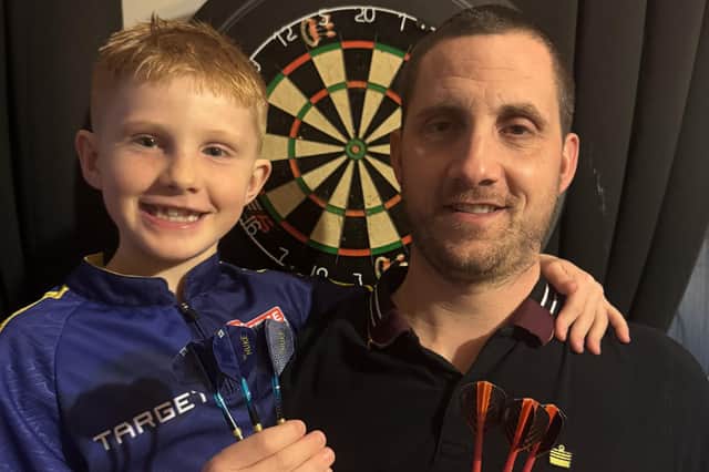 Talented schoolboy darts player Jake Moore (8) with his proud dad Shane