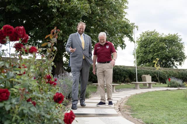 Tim Collins (Barratt Redrow Group Corporate Affairs Director) and Alec Wilson (Friends of the Tenth) walk down the memorial pathway at Burrough-on-the-Hill