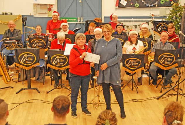 Belvoir Big Band treasurer and baritone sax player, Dr Liz Pearce (left) presents a cheque for £1,000 to Alzheimer's Society volunteer, Jennie Adey