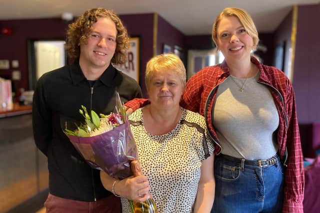 Lesley Parker clocks up 35 years at The Regal cinema in Melton - she pictured with owners Jacob and Bryony Mundin after they presented her with flowers and fizz
