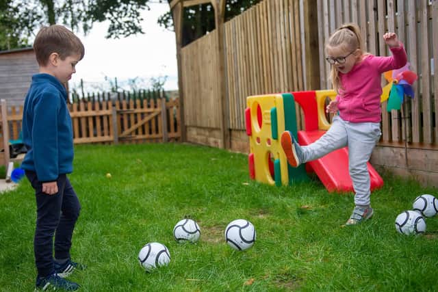 Youngsters at Melton's Little Rascals Day Nurseries enjoy playing with their new mini footballs donated by Barratts