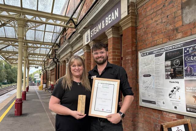 Robbie and Caroline Stephen with their business award outside Steam & Bean