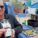 Ken Palmer holding his latest bag of blood after making his 10 donation at Melton
