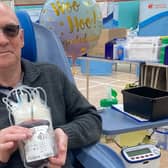 Ken Palmer holding his latest bag of blood after making his 10 donation at Melton