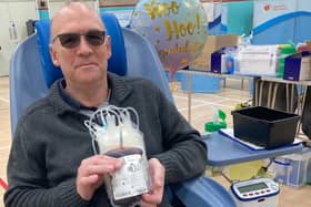Ken Palmer holding his latest bag of blood after making his 10 donation at Melton
