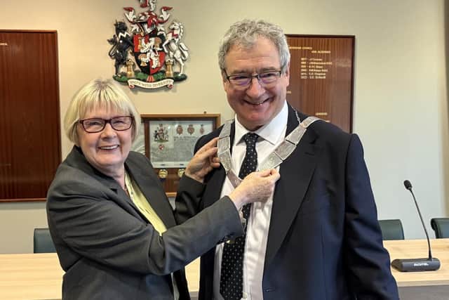 Councillor Jim Adcock - the new Mayor of Melton - receives the chains of office from his predecessor, Councillor Siggy Atherton