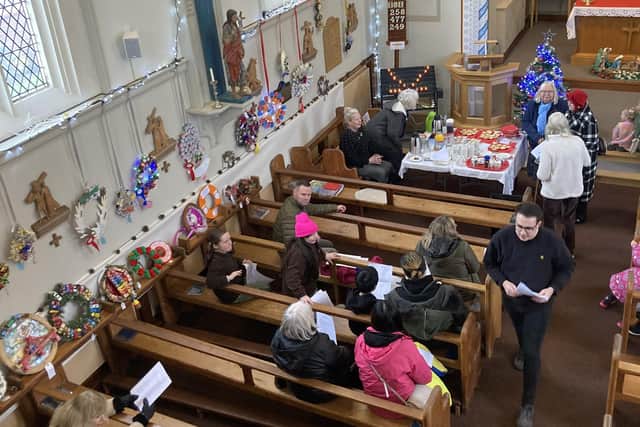 Christmas wreaths line the walls of St John's Church in Melton during the festival