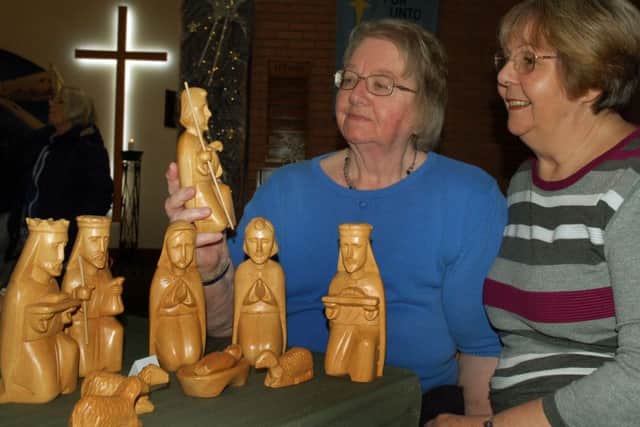Organisers Margaret Phillips and Jen Hanson with a wooden nativity set from the Phillipines PHOTO: Tim Williams
