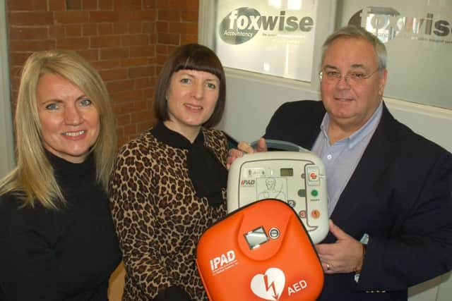 Holwell Sports FC deputy chairman Martin Rooney takes delivery of the club's new defibrillator from Alicja Mogg and Sarah Amos, directors of Foxwise Accountancy, of Melton EMN-170112-153902001