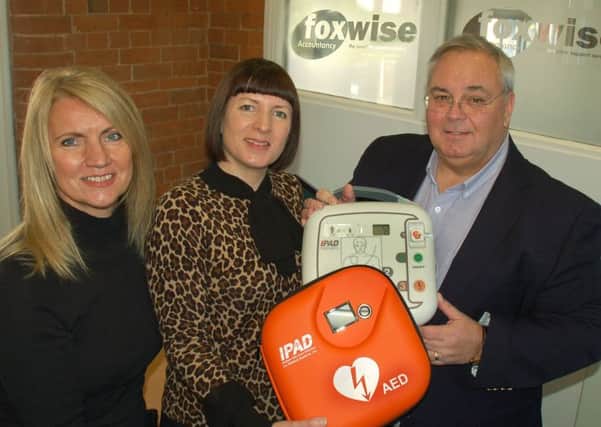 Holwell Sports FC deputy chairman Martin Rooney takes delivery of the club's new defibrillator from Alicja Mogg and Sarah Amos, directors of  Foxwise Accountancy, of Melton EMN-170112-153902001