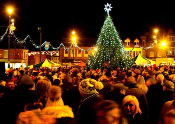 The Christmas tree and lights glow in the town centre EMN-170412-105736001