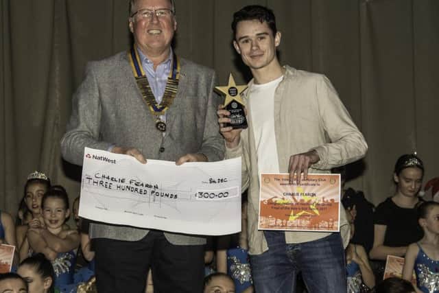President of the Vale of Belvoir Rotary Club Adrian Cresswell presenting Charlie Fearon with his trophy and £300 for winning PHOTO: Supplied